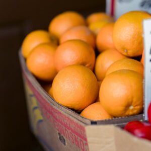Vibrant oranges for sale at a local market, emphasizing freshness and healthy nutrition.